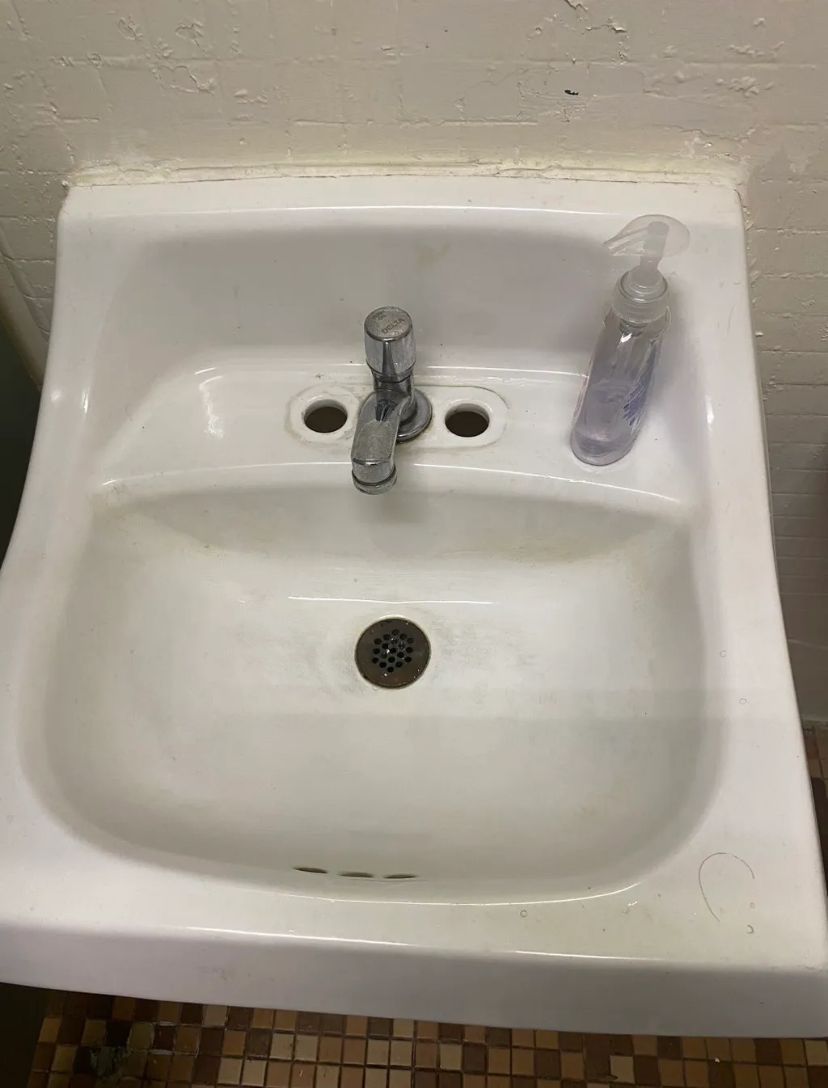 A white bathroom sink with a soap dispenser next to it. BEFORE/AFTER