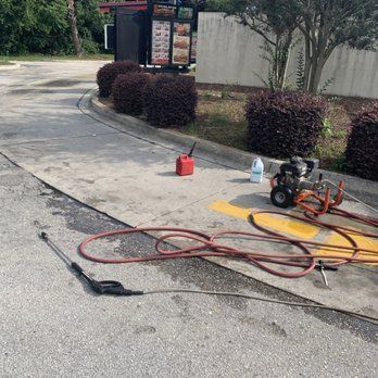 A pressure washer is sitting on the side of the road next to a gas can.  BEFORE/AFTER