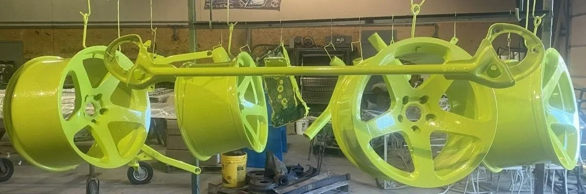 Bright green car wheels hanging in a workshop.