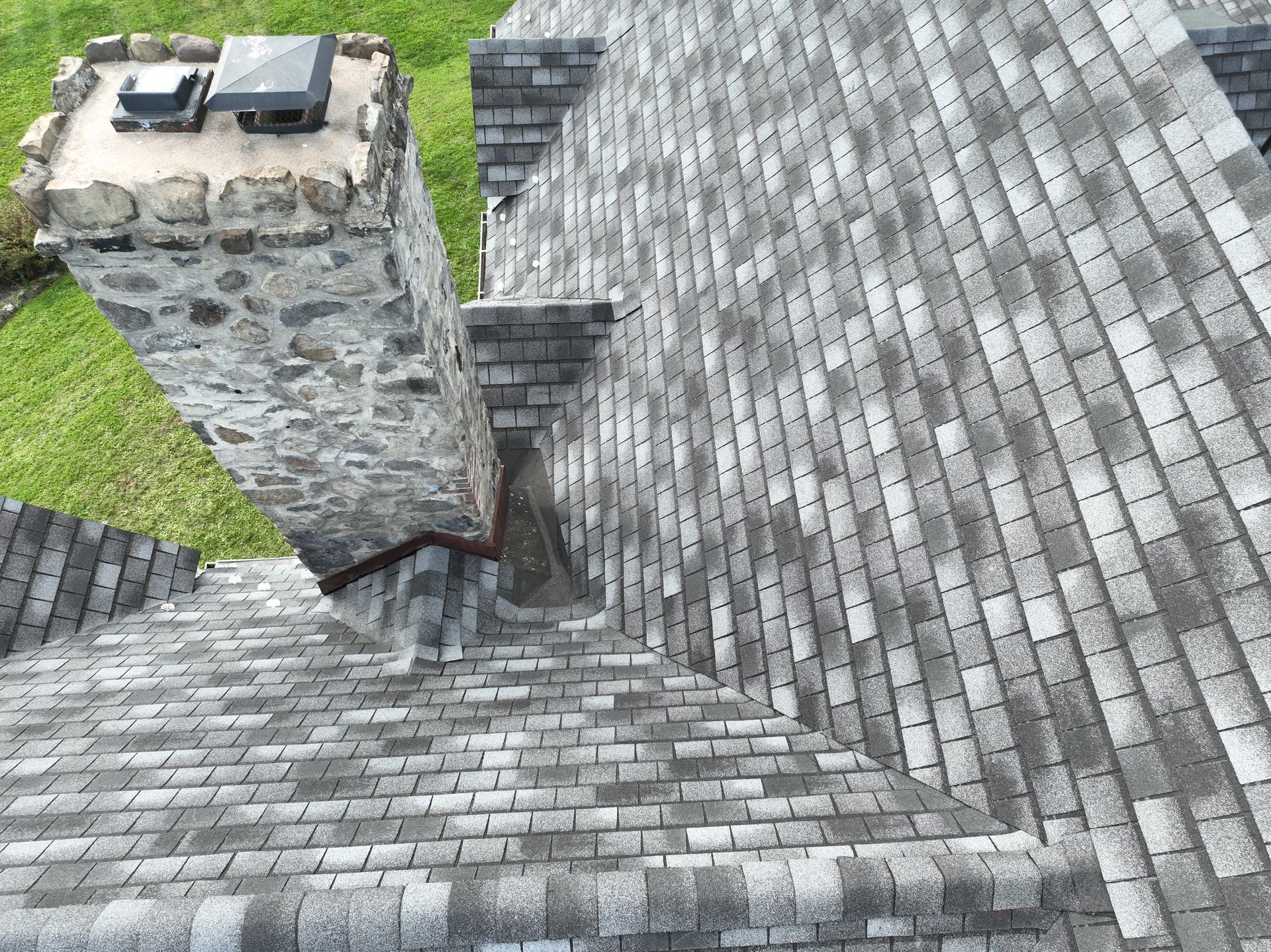 An aerial view of a roof with custom asphalt shingles