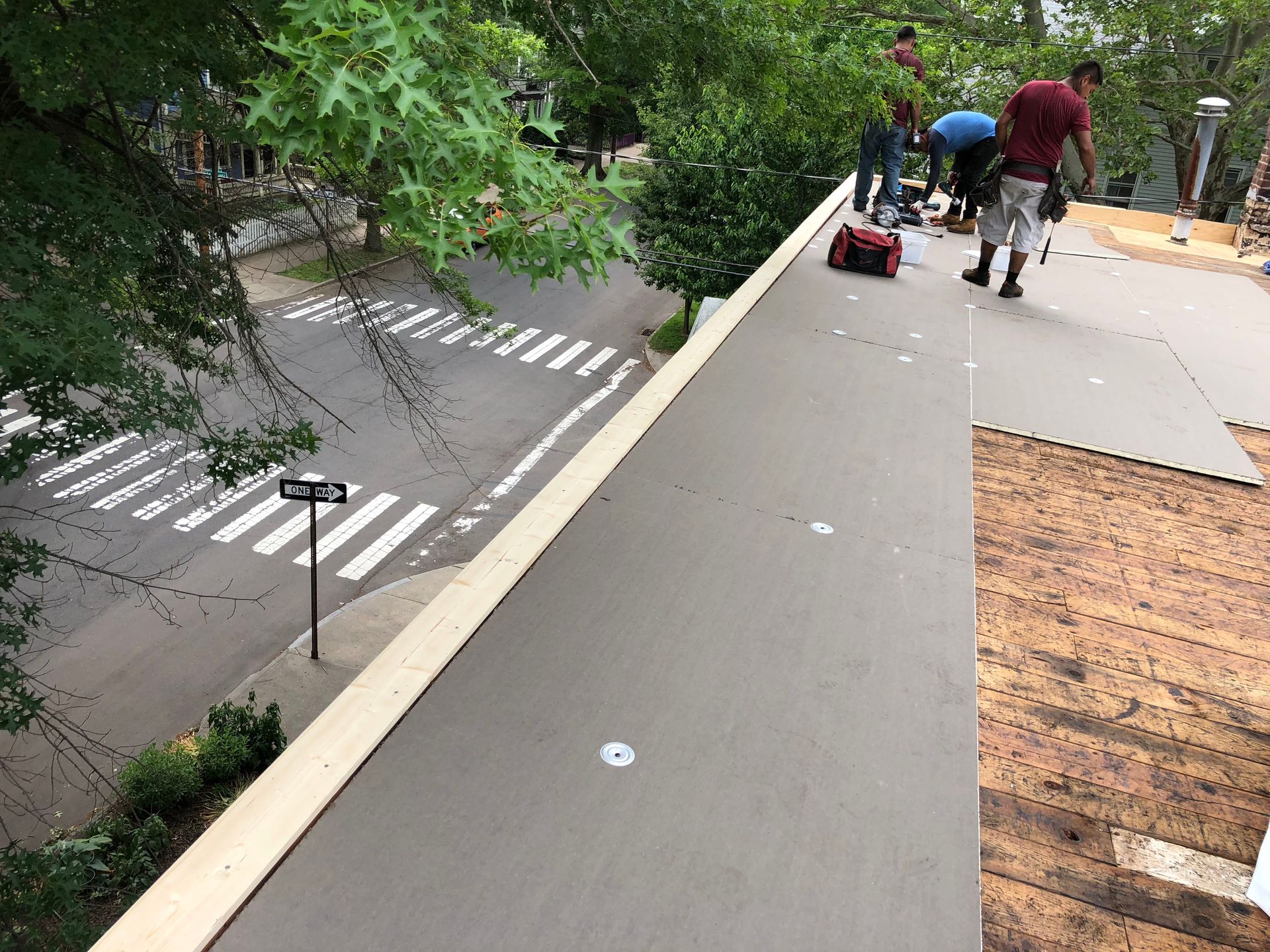 A group of people are working on a commercial flat roof