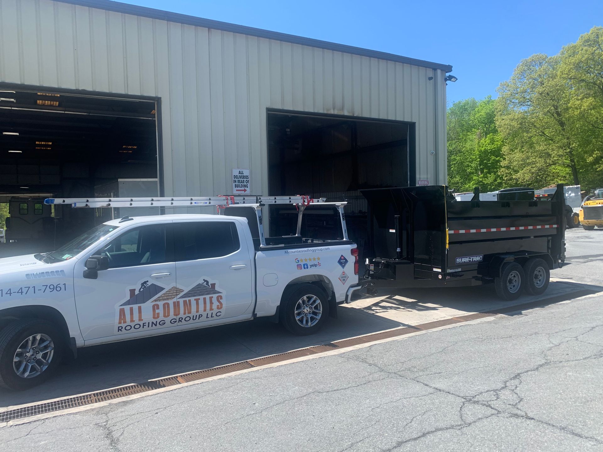 All Counties Roofing Group truck in front of commercial roof replacement