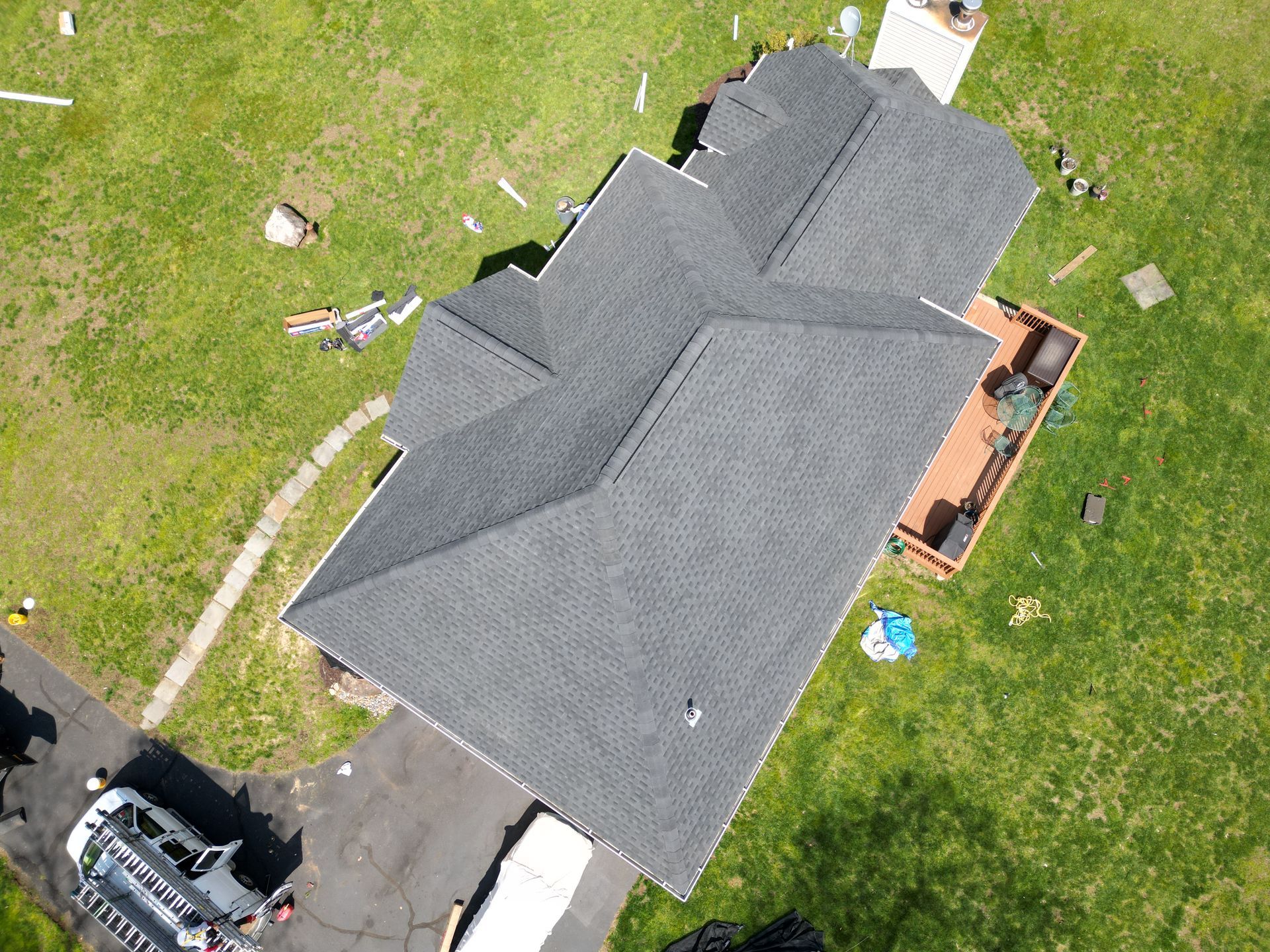 An aerial view of a house with a roof that is being repaired.