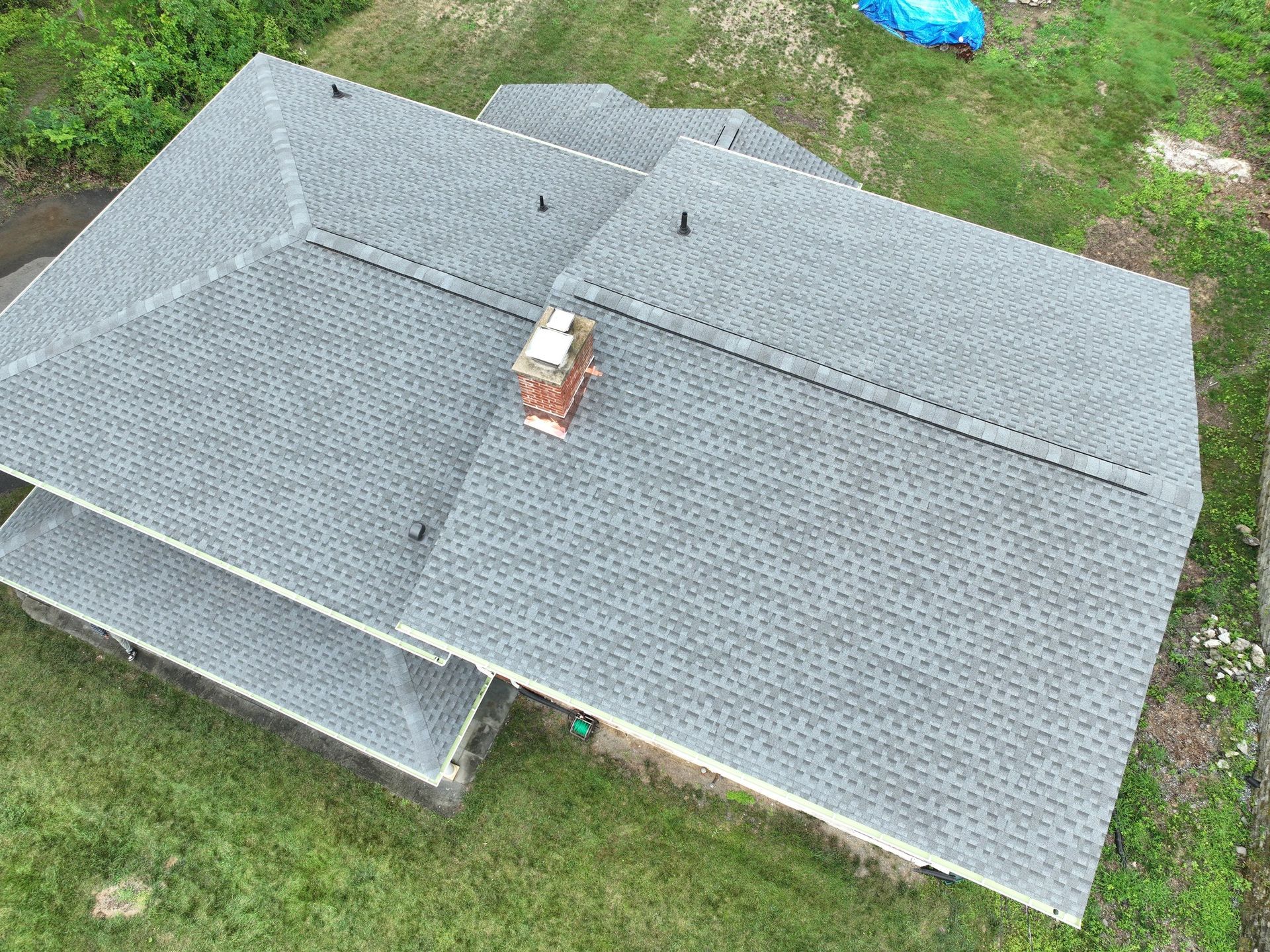 An aerial view of a house with a chimney on the roof.