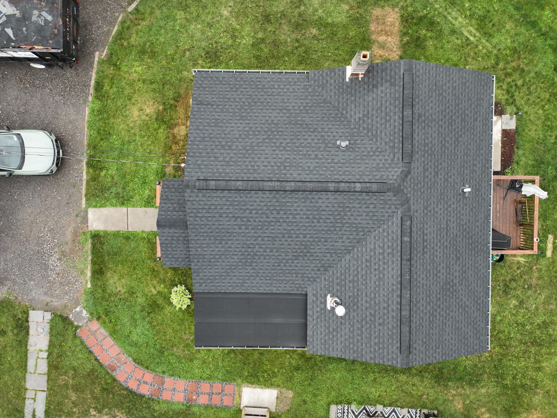 An aerial view of a house with a black roof installation