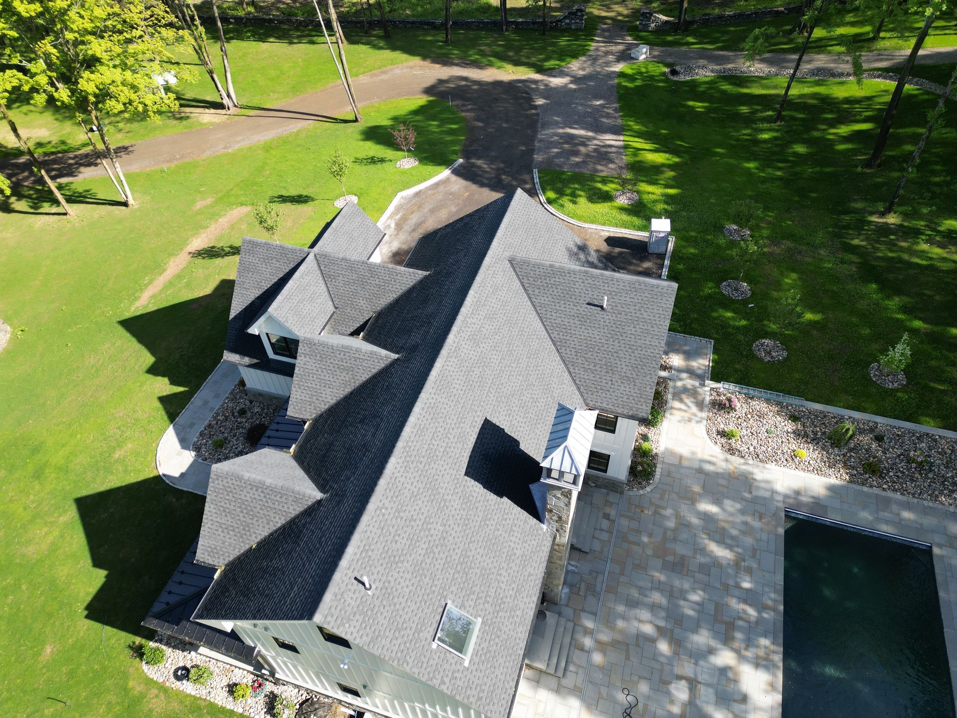 An aerial view of a large house with roof replacement