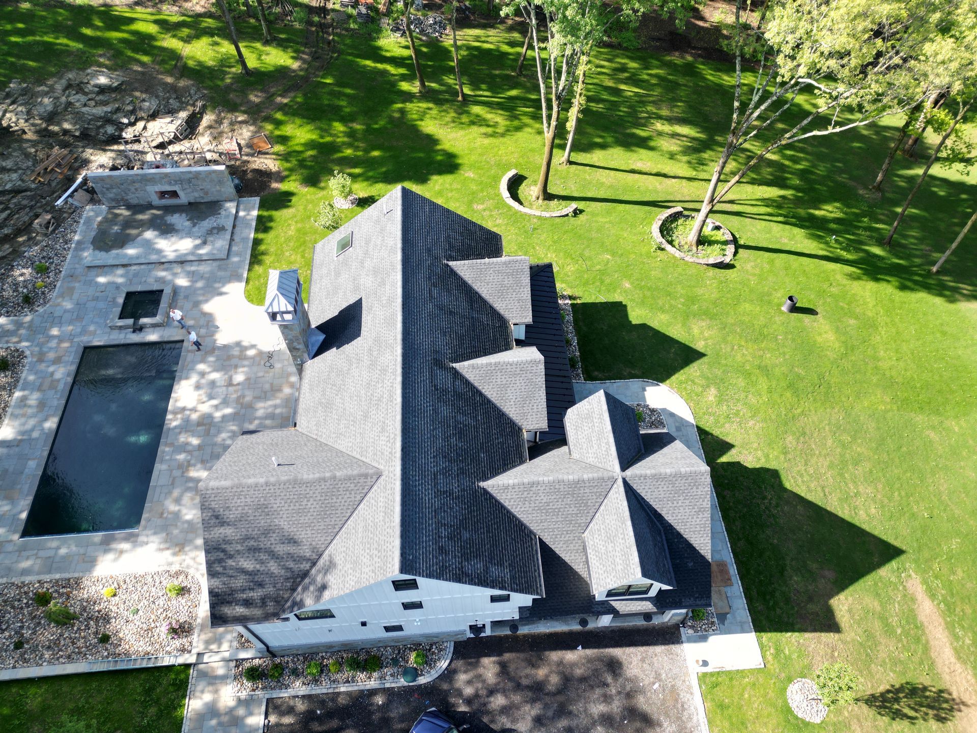 A side aerial view of a house with new roof replacement