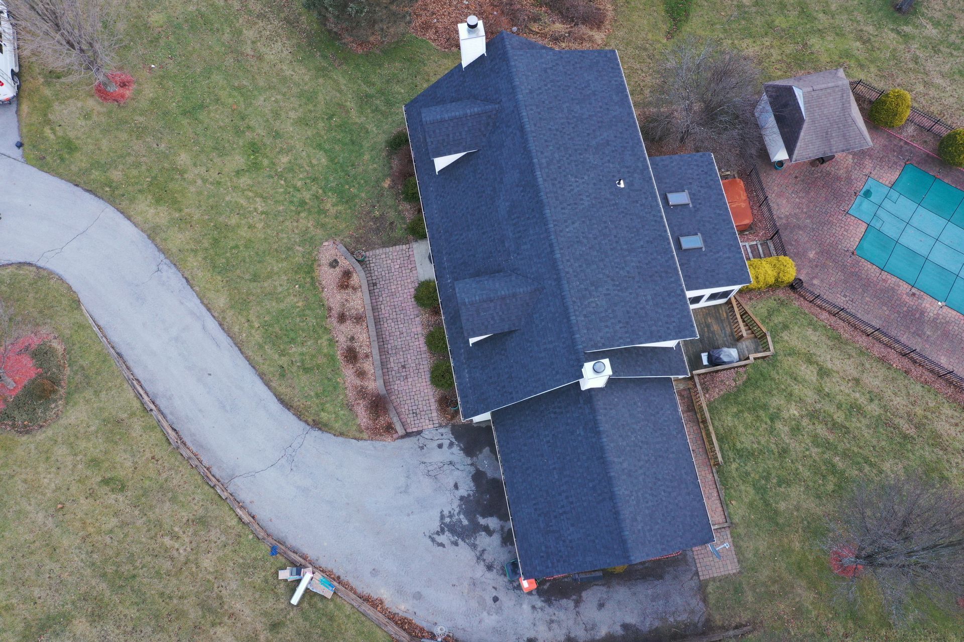 Dark roof replacement on white home top, front view