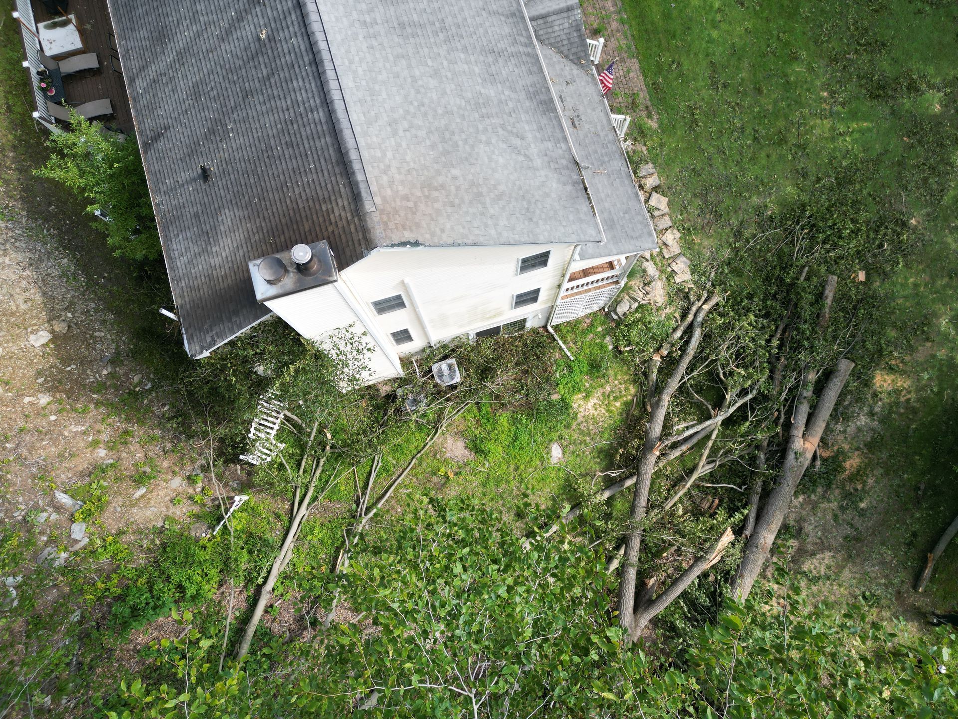 An aerial view of a house with a roof that is being repaired from storm damage