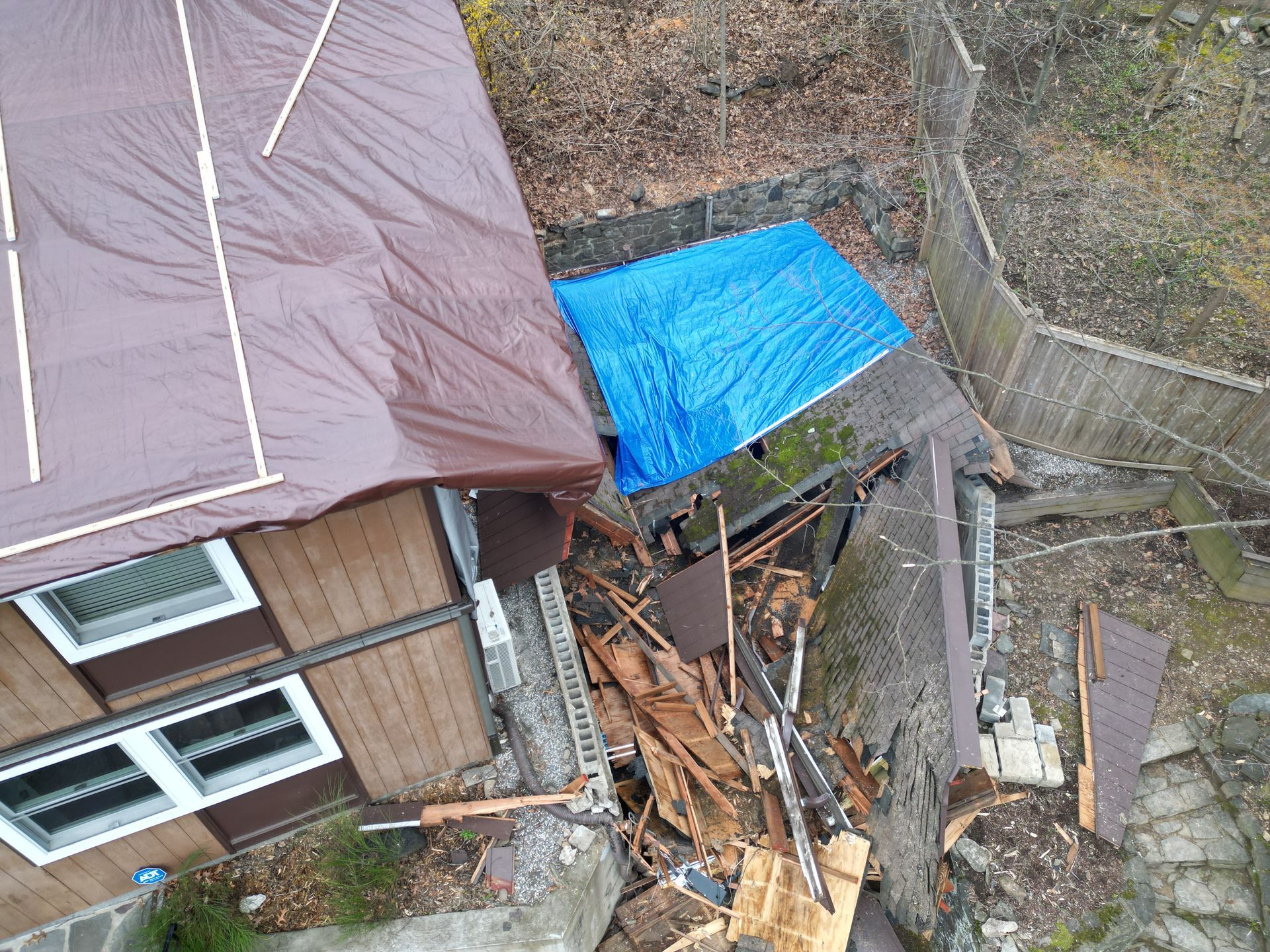 Side of a home that suffered large damage and being repaired both roof and siding for emergency services