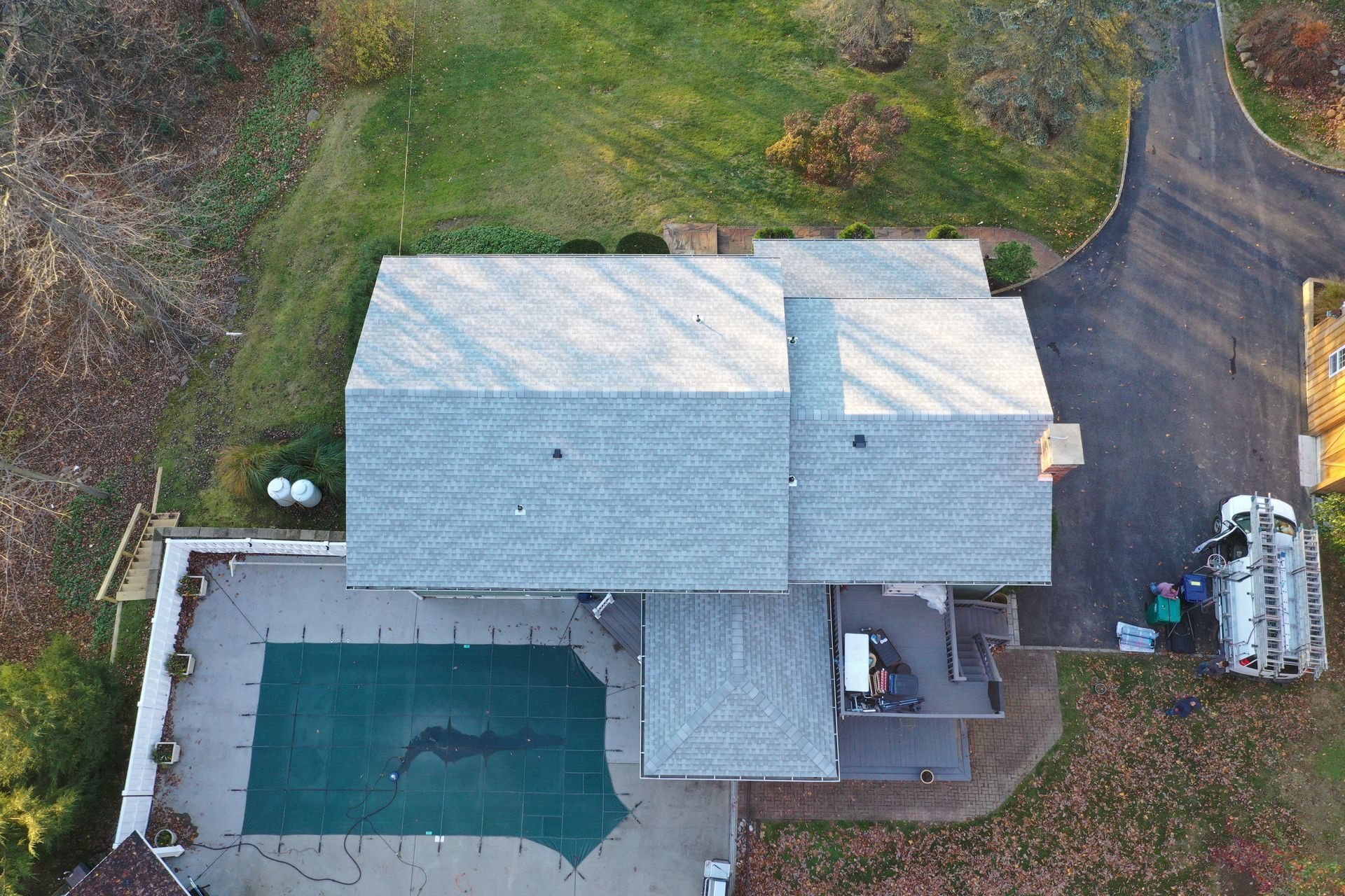 Top side view of gray roof replacement on green house