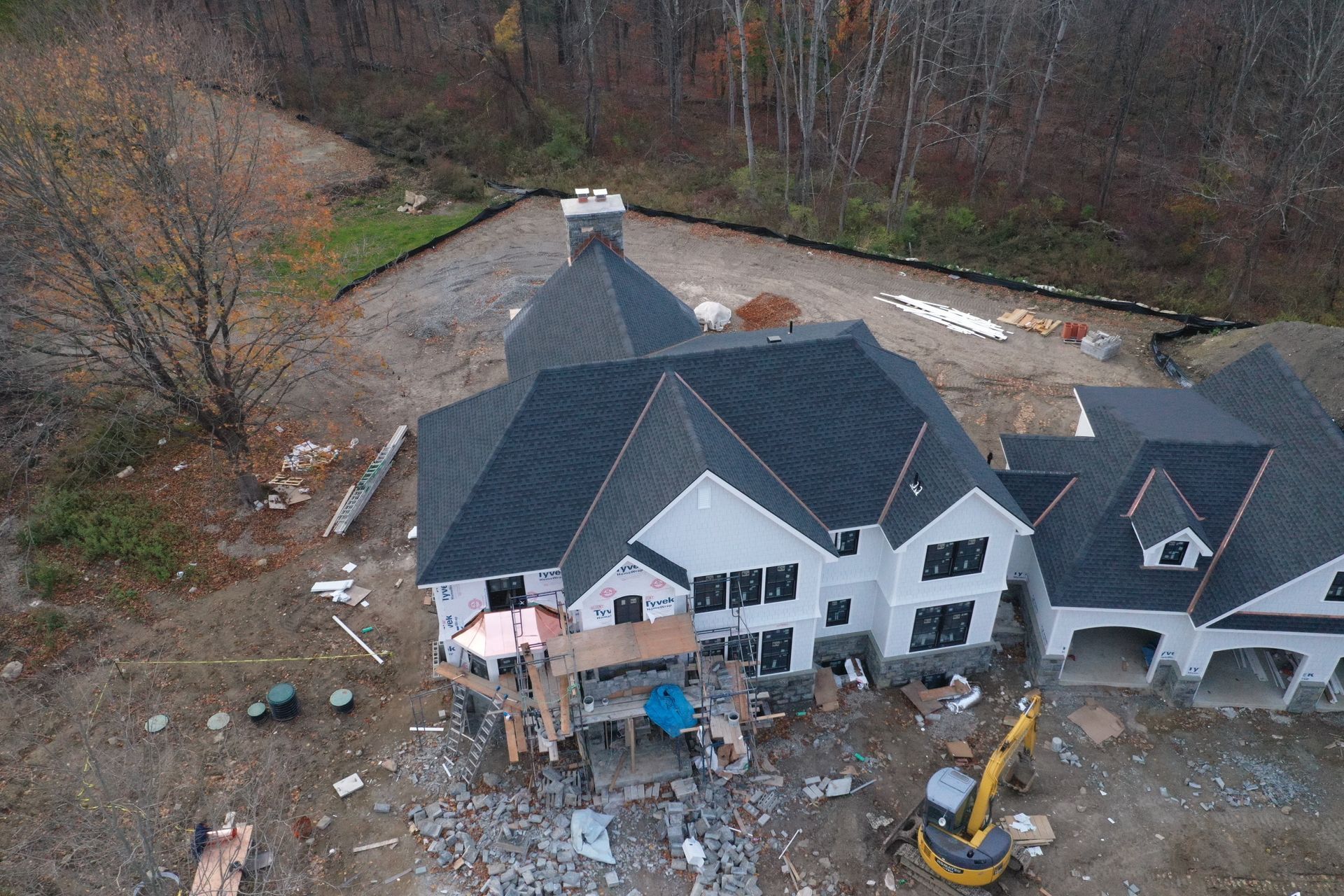 New dark roof installation on white home, new build with copper work