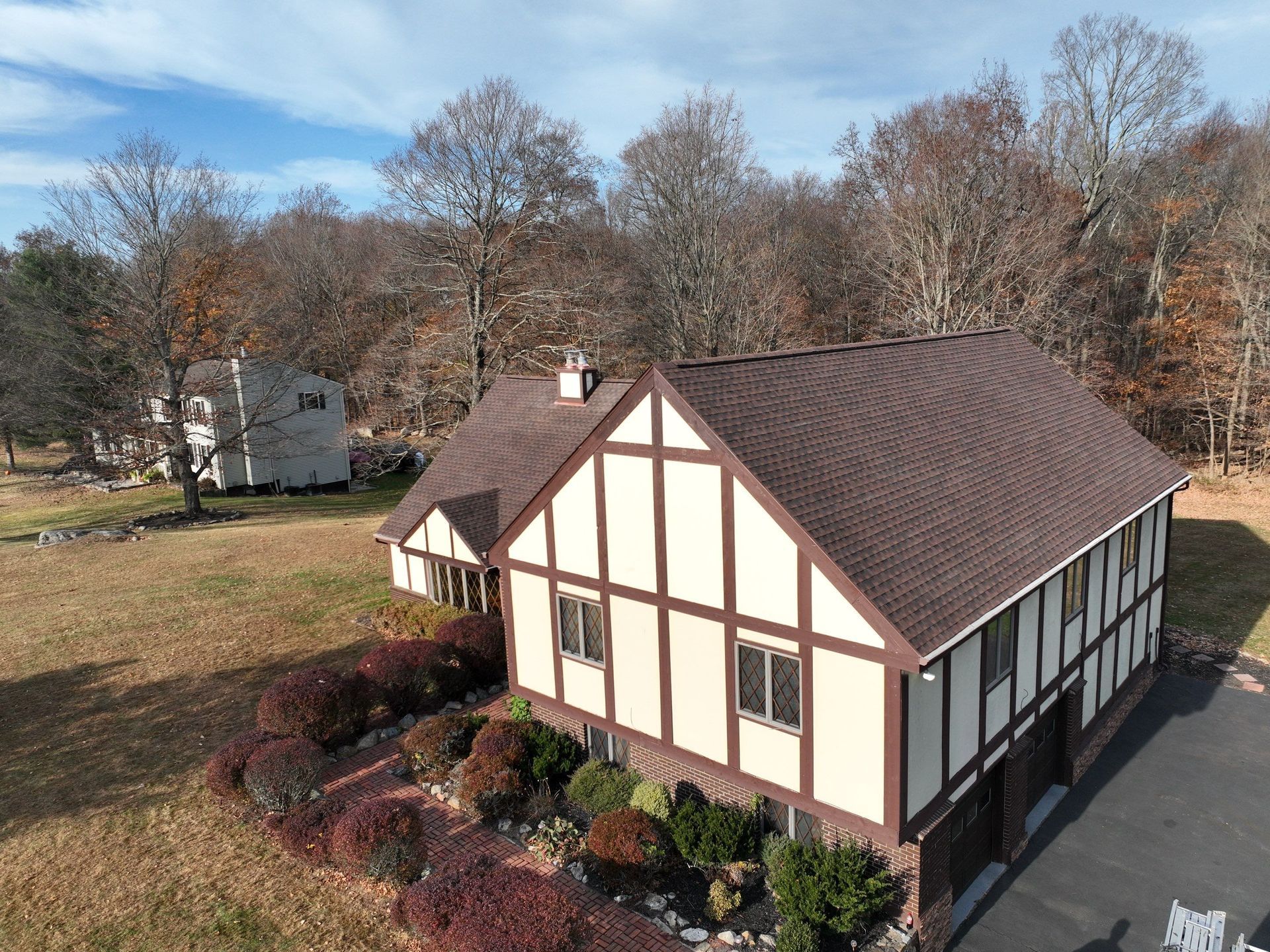 A front view of a house with a brown roof replacement