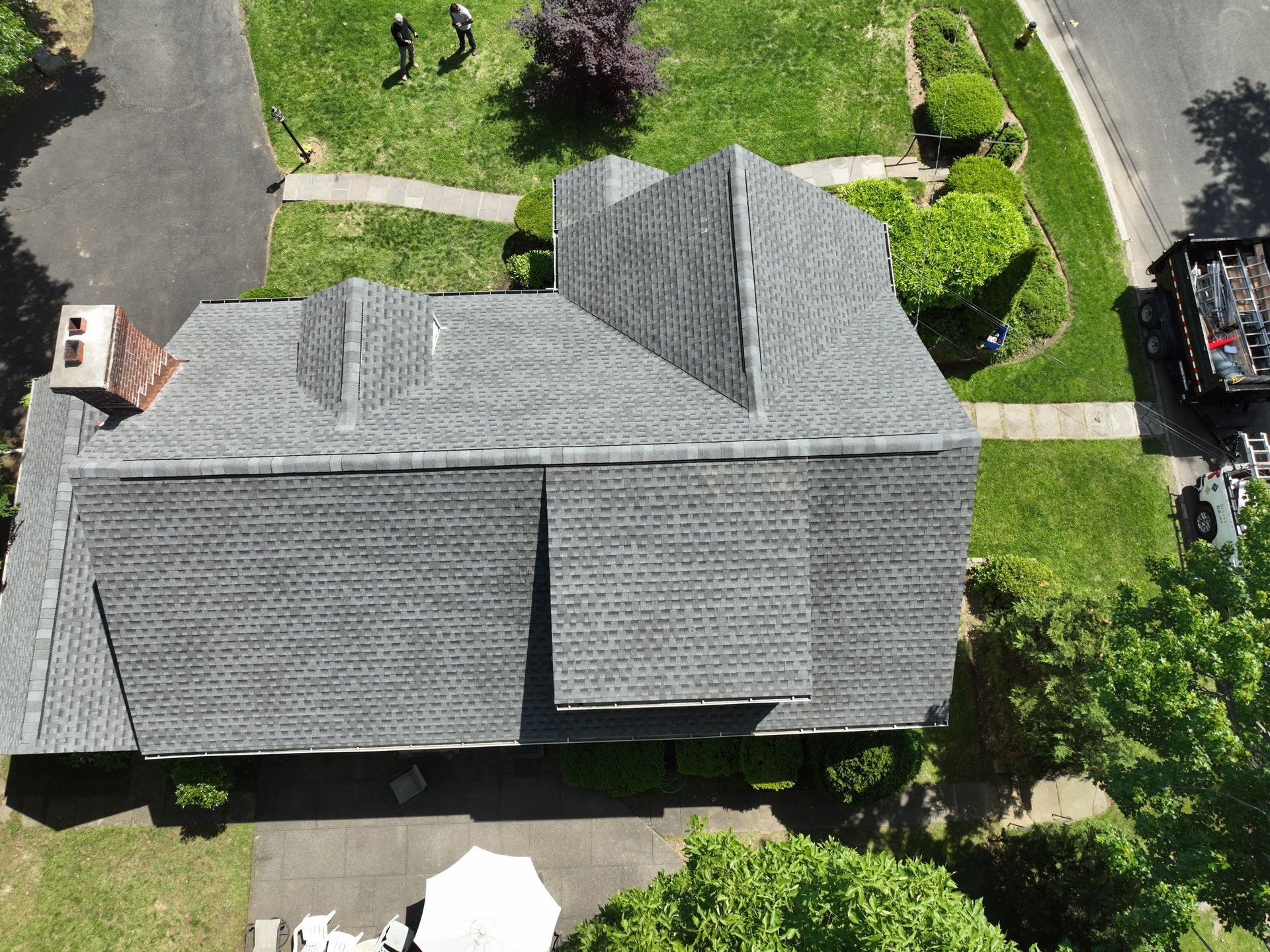 A top aerial view of a house with a roof that is being replaced