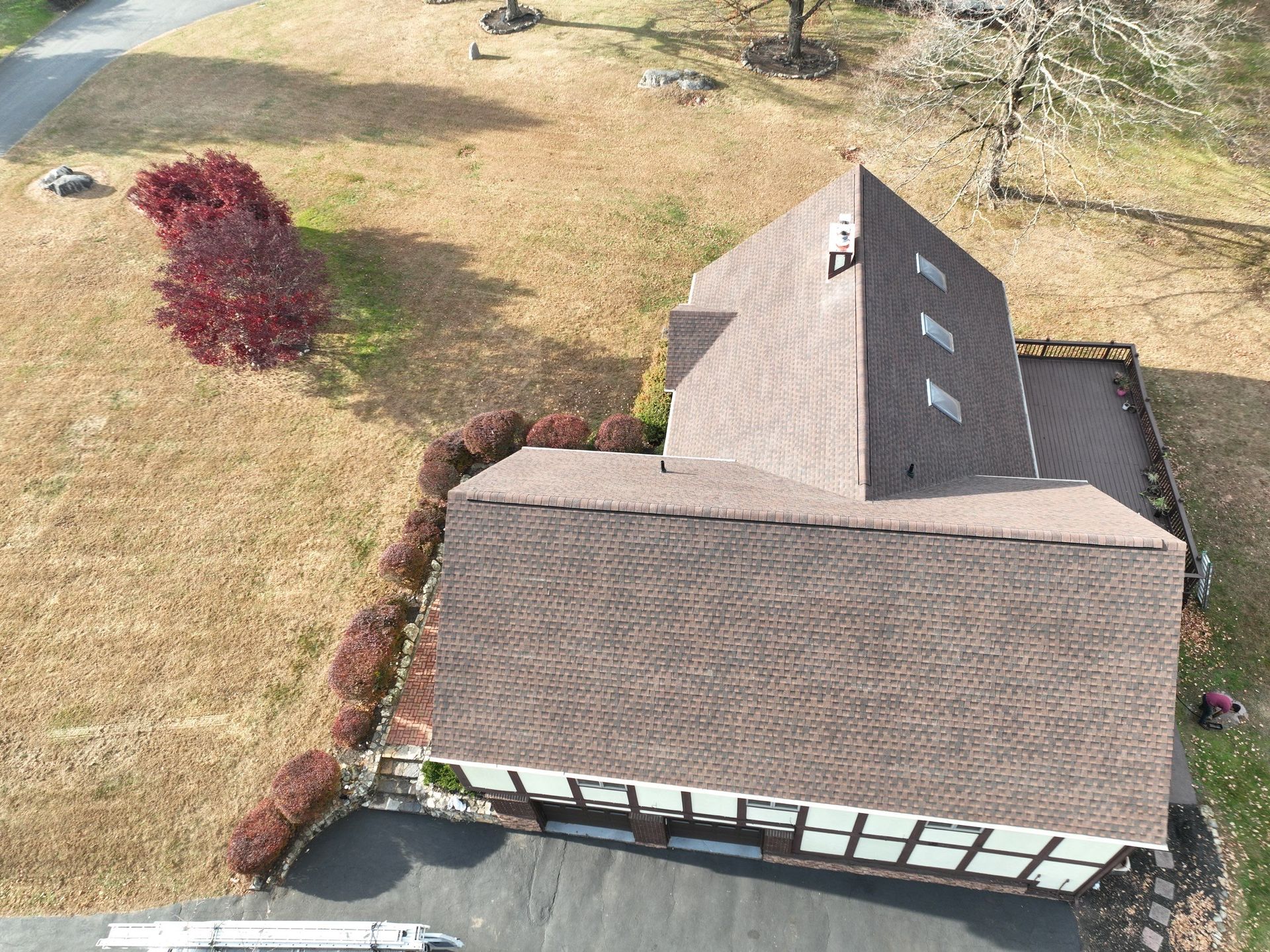 An aerial view of a house with a brown roof replacement