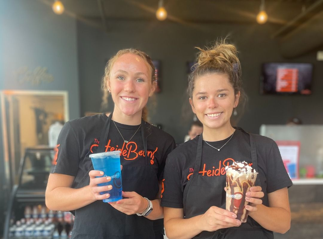 A man in a chef 's hat is posing for a picture with two other chefs