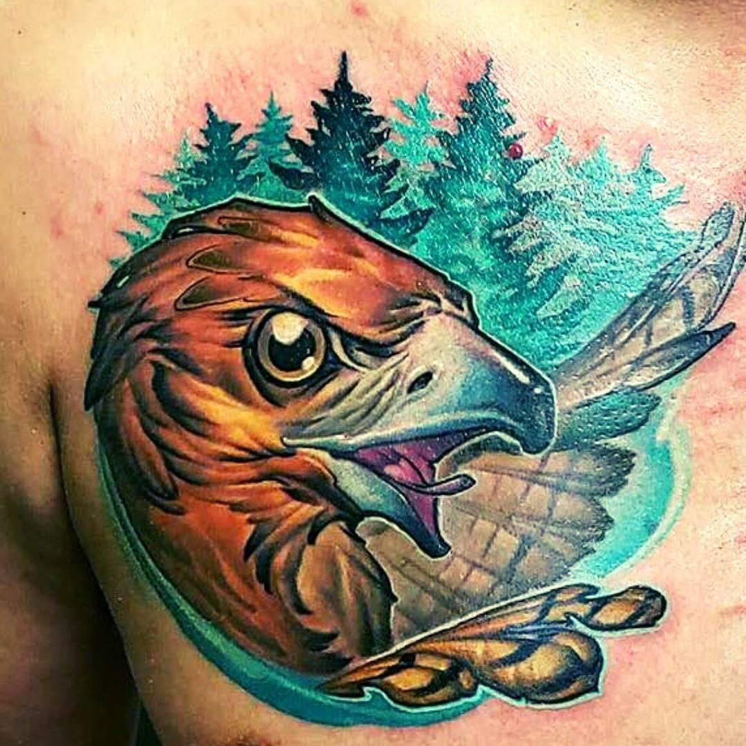 Tattoo of a hawk's head with an angry expression.