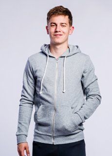 A young man is wearing a grey hoodie with a zipper.