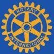 A yellow and blue rotary international logo on a blue background.