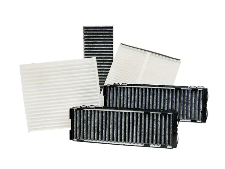 Several rectangular automotive cabin air filters, varying sizes, some black, some white.