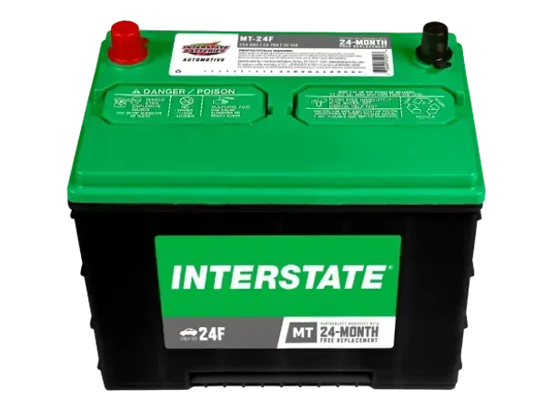Green and black Interstate car battery with red and black terminals, white background.