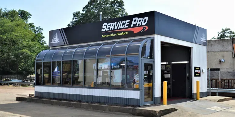 Service Pro automotive shop with glass front, sign above garage.