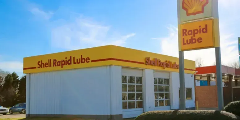 Shell Rapid Lube building under a blue sky with a sign that says 