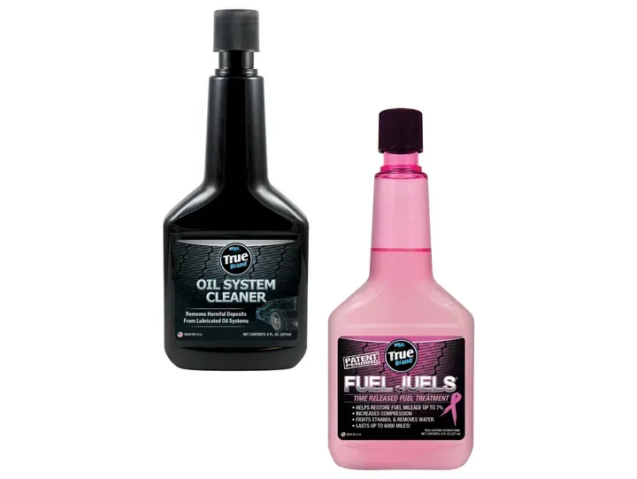 Two bottles of car additives: black Oil System Cleaner and pink Fuel Juels.