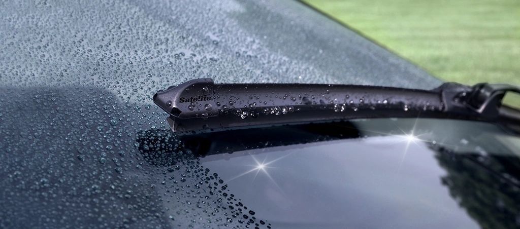 Pouring oil from a gray container into a car engine, showcasing yellow liquid and a blurred background.