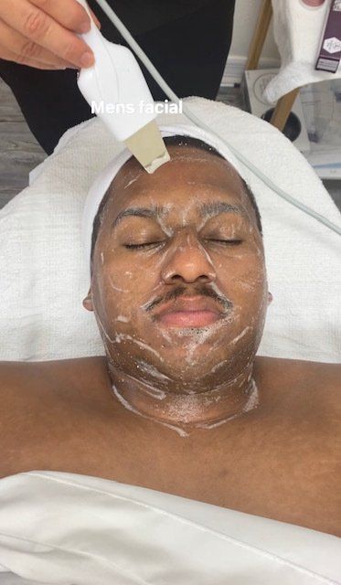 male client receiving facial