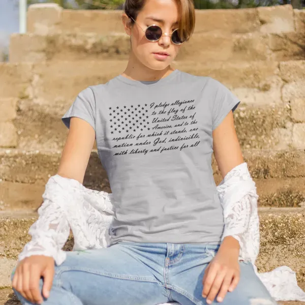 A woman wearing a gray t-shirt with an american flag on it