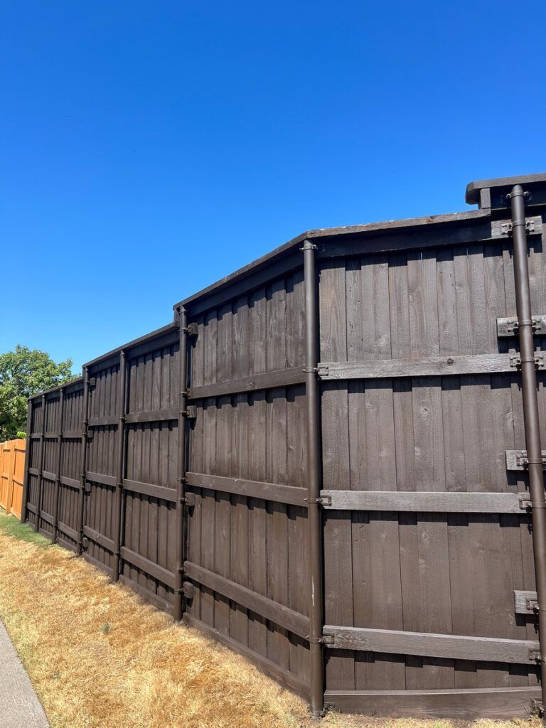 A wooden fence with a blue sky in the background