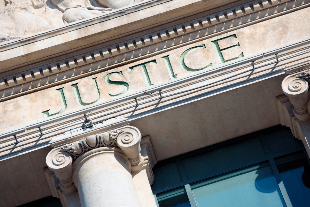 The word justice is on the front of a building.