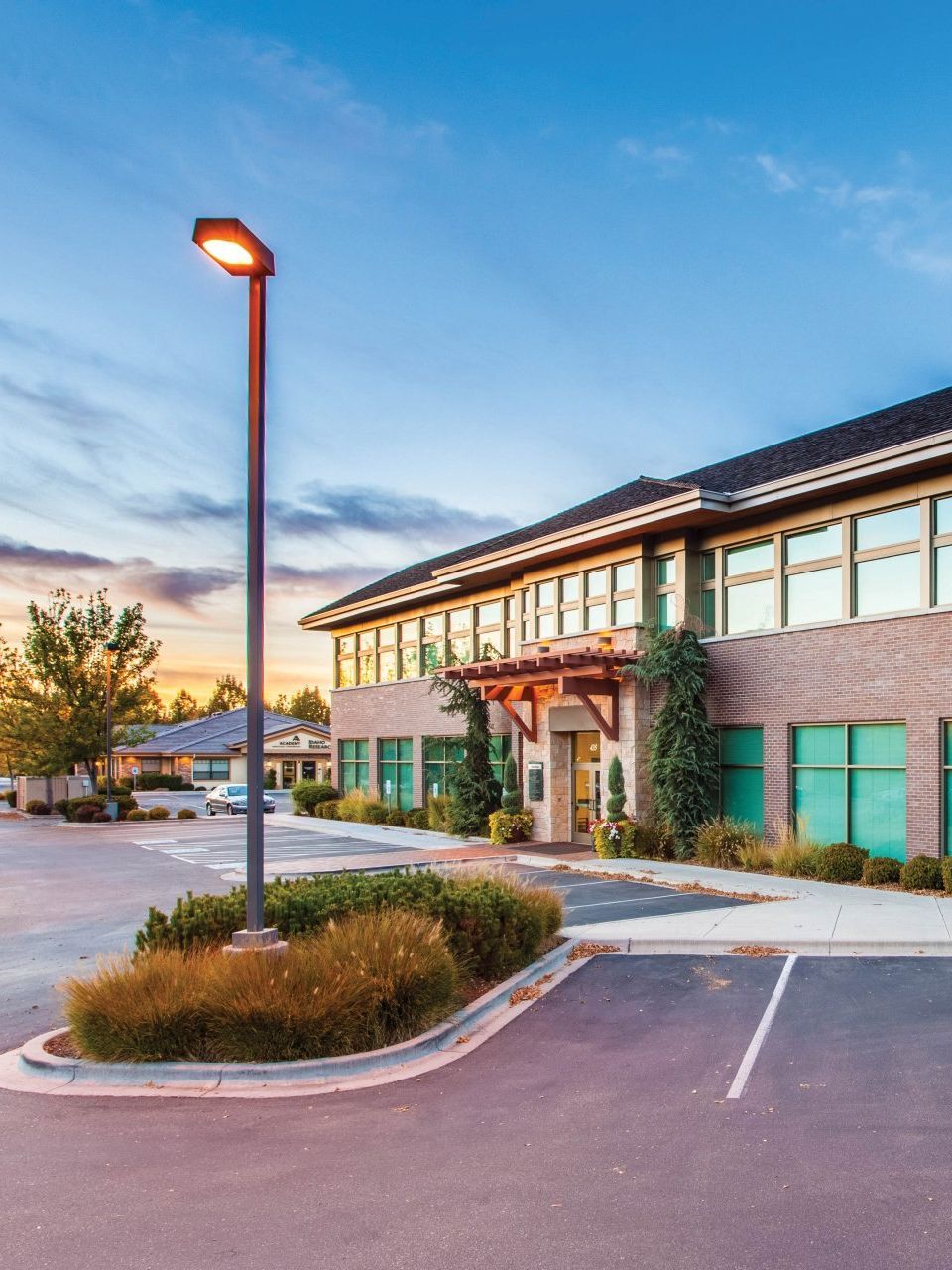 A large building with a parking lot in front of it