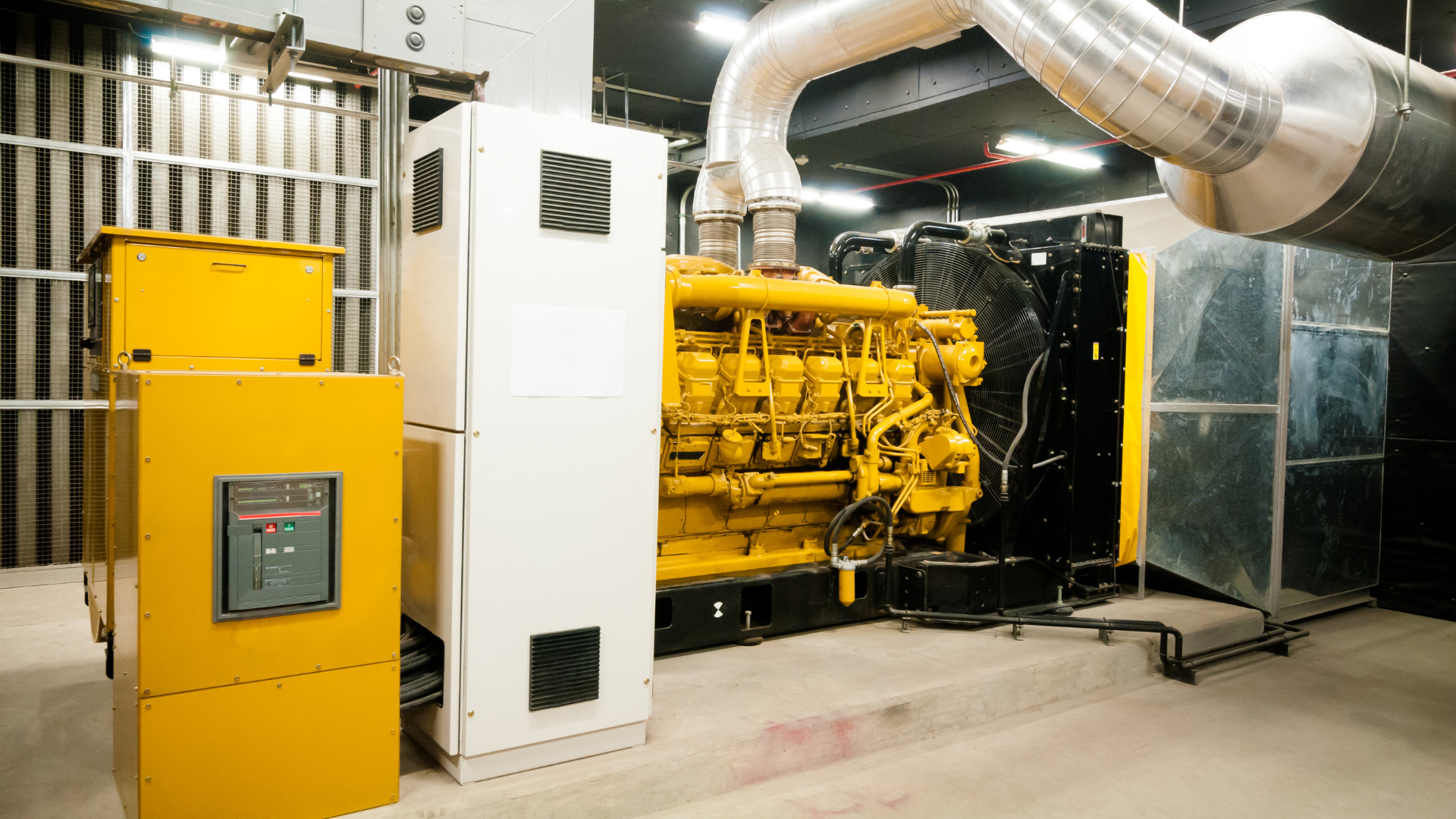 A kitchen with white cabinets , stainless steel appliances , wooden floors and a large island with chairs.