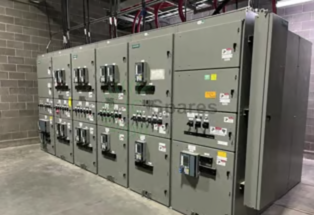 A row of electrical panels in a room with a brick wall