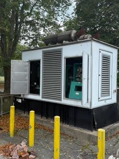 A large white building with a green machine inside of it.