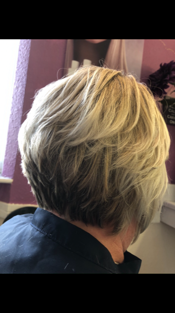 woman showing her short colored hair