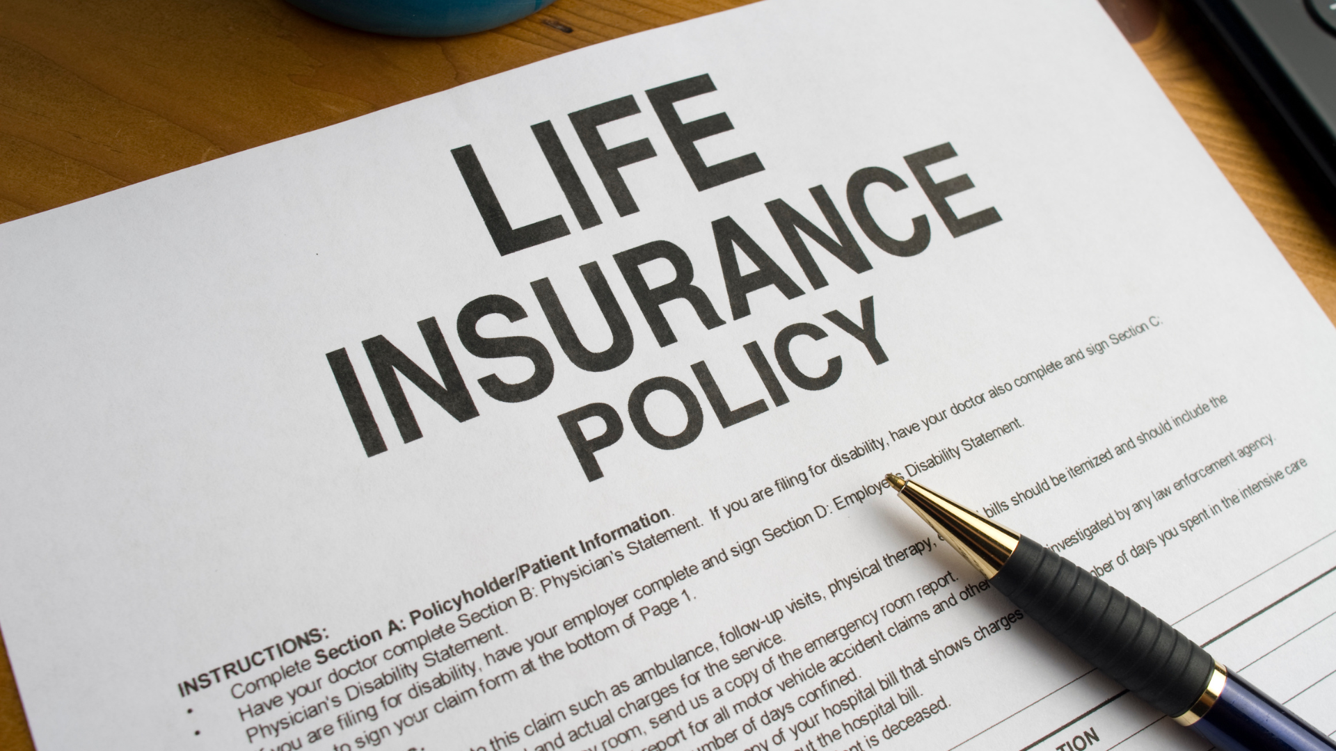A pen is sitting on top of a life insurance policy.