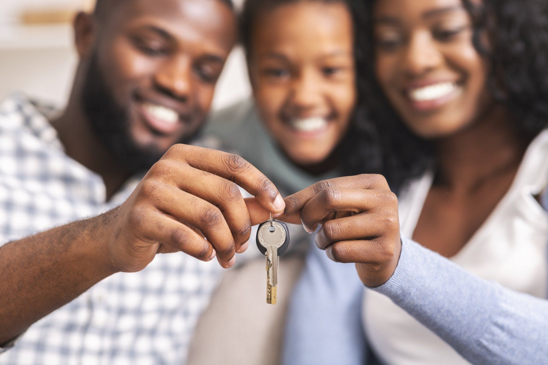 Happy family holding keys - Cypress, CA - Gibson Realty