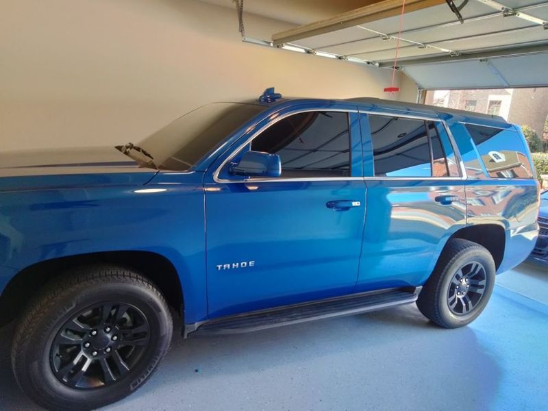 A blue suv is parked in a garage.