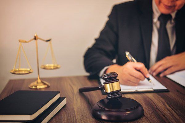Law Firm — Gavel On Table And Lawyer Working With Agreement in Redding, CA