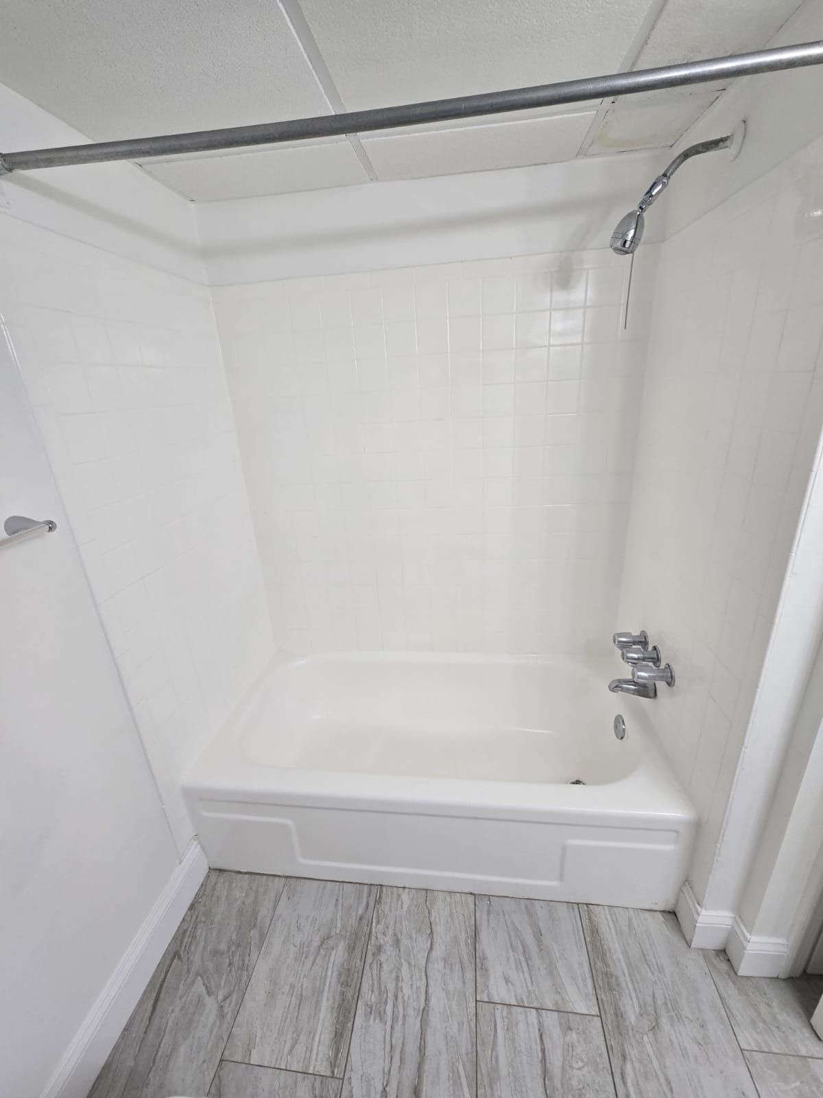 Bathroom shower area with tile and shower curtain at Chateau Apartments Burlington, NJ