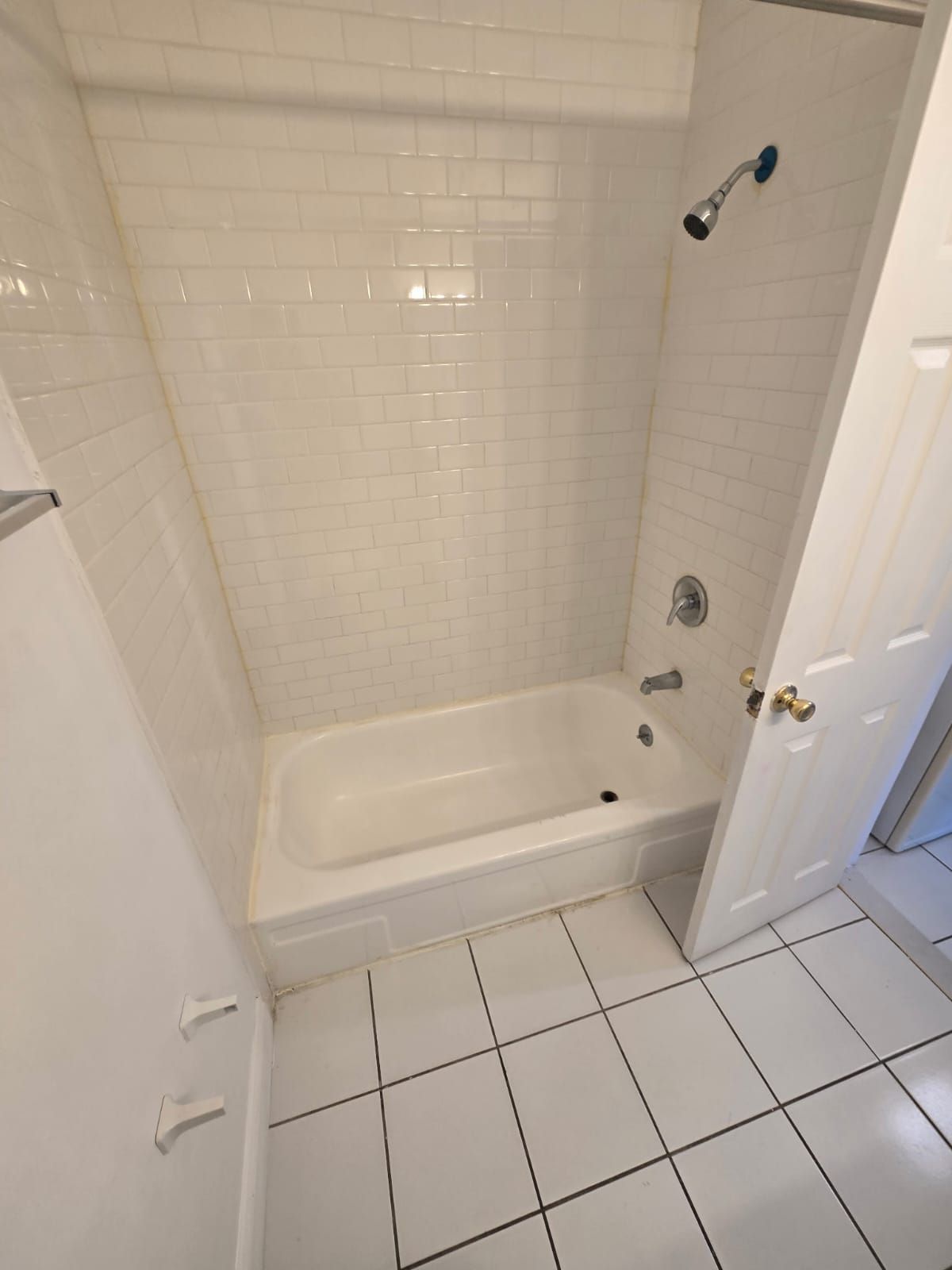 White bathtub with tiled walls in modern bathroom at Chateau Apartments Burlington, NJ