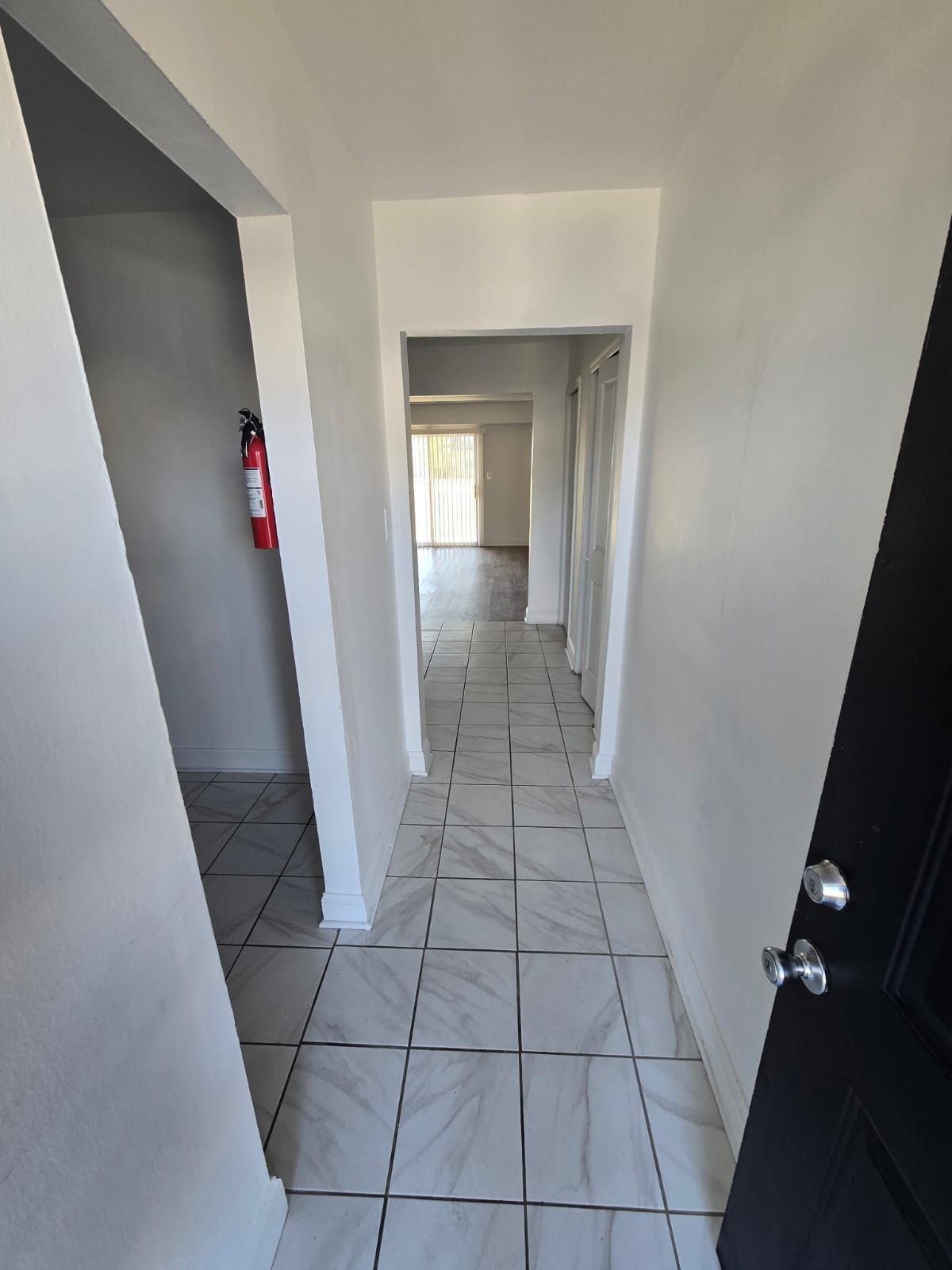 Clean hallway with white walls and natural light at Chateau Apartments Burlington, NJ