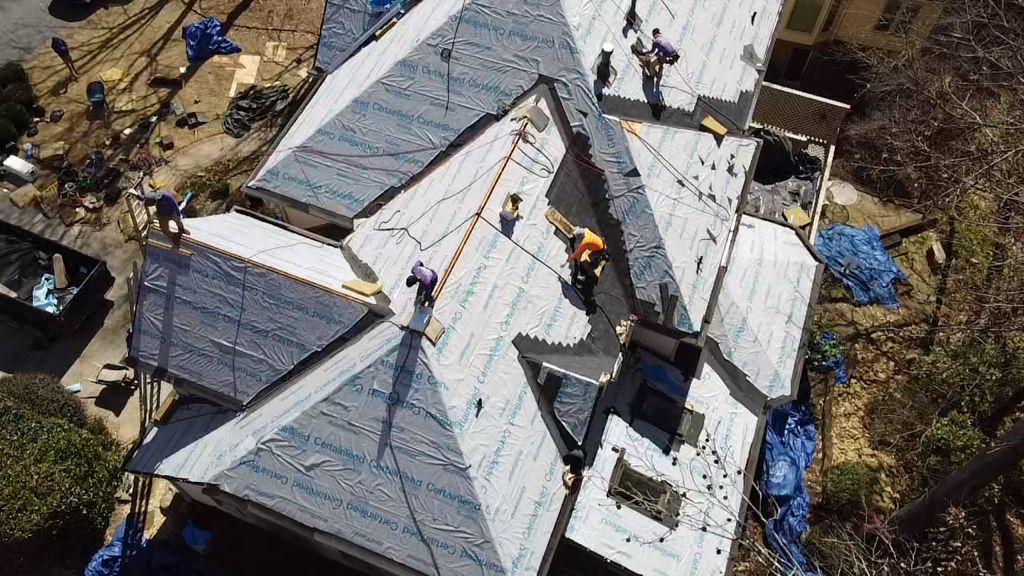 An aerial view of a roof being installed on a house.