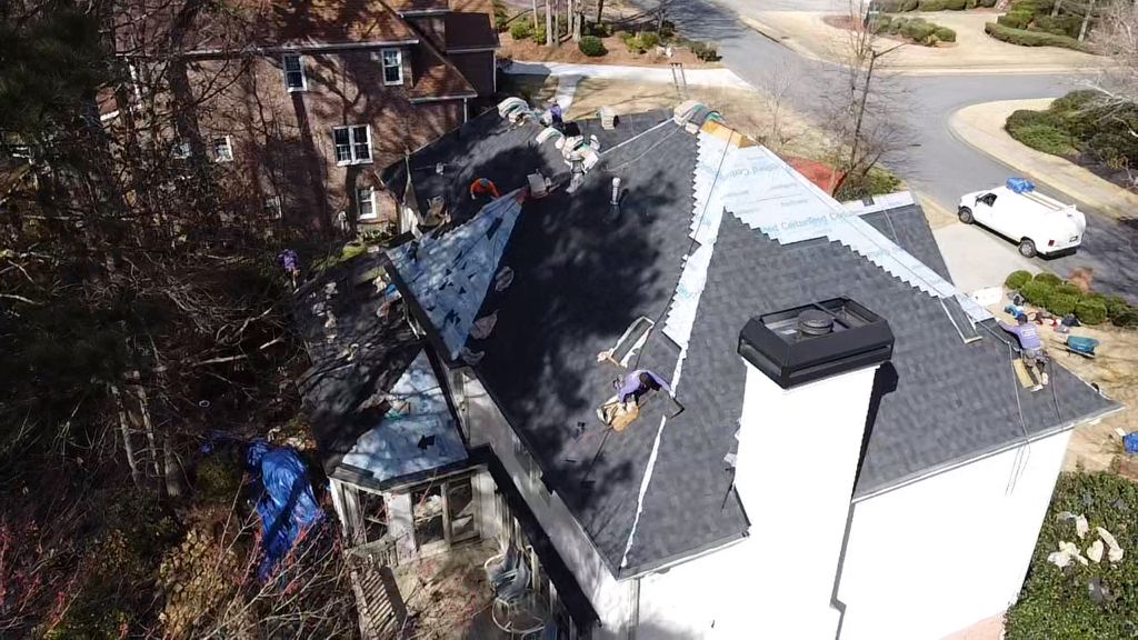 An aerial view of a roof being installed on a house.