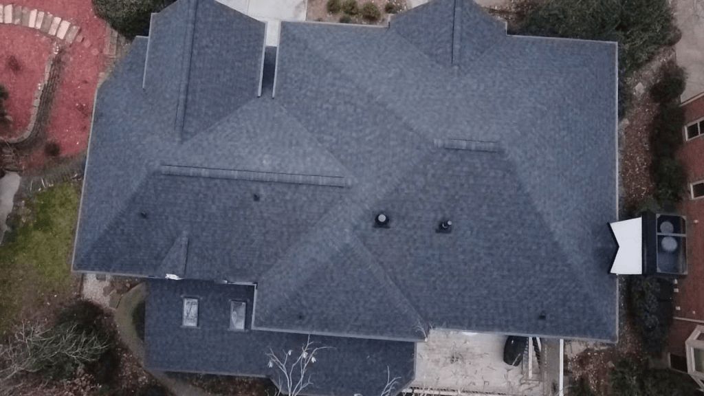An aerial view of a large house with a roof.