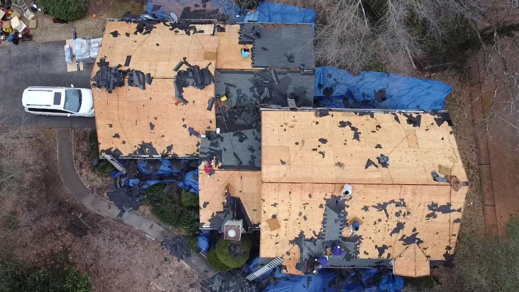 An aerial view of a house under construction with a truck parked in front of it.