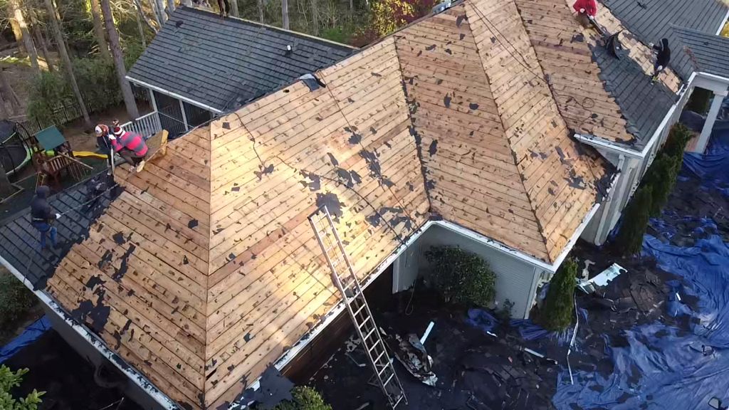 An aerial view of a roof being installed on a house.